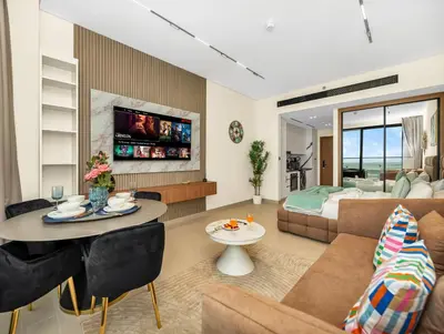 a living room with a couch and a table at Modern Studio Private Jacuzzi Canal View in Dubai