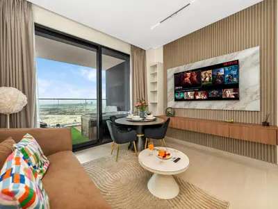 a living room with a couch and a table at Modern Studio Private Jacuzzi Canal View in Dubai