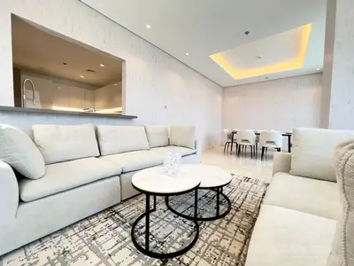 a living room with a couch and a table at Modern & Stylish 2BR Apartment in Dubai