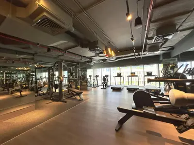 a gym with several treadmills and machines in a room at Modern & Stylish 2BR Apartment in Dubai