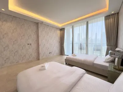 a hotel room with two beds and a large window at Contemporary Urban 2BR Apartment in Dubai