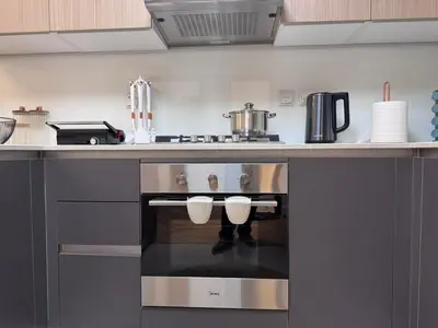 a kitchen with a stainless steel oven in a kitchen at Spacious Designer Home Pool, Gym & Playground in Dubai