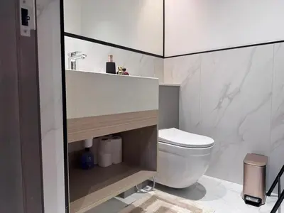 a bathroom with a white toilet and a sink at Spacious Designer Home Pool, Gym & Playground in Dubai