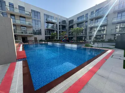 a large swimming pool in front of a building at Spacious Designer Home Pool, Gym & Playground in Dubai
