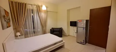 a small room with a bed and a chair in it at Zaman Vacation Homes in Dubai
