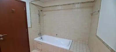 a bathroom with a bath tub in a tiled room at Zaman Vacation Homes in Dubai