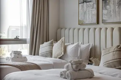 two beds with teddy bears on them in a room at 2BR Burj & Fountain View 5 mins to Dubai Mall in Dubai