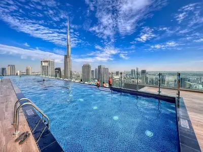 a swimming pool on the roof of a building at Spectacular Burj View from Infinity Pool in Dubai