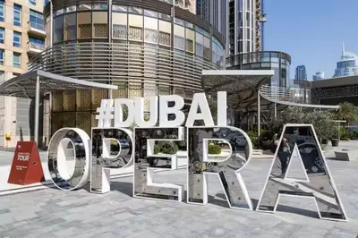 a large metal sign in front of a building at Vogue Downtown Act One near Burj Khalifa and Dubai Mall, Two Bedroom Apartment with Balcony and City Skyline View, Access to All Amenities in Dubai
