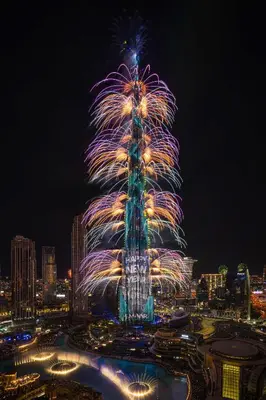 a fireworks display in front of a tall tower at Grande Signature Residence 907 Full Burj Khalifa and Dubai Dancing Fountain View 5 Min Walk Dubai Mall Luxury Downtown Apartment in Dubai