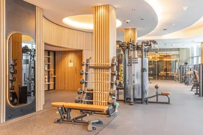 a gym with a bench and some exercise equipment at StayShort - Stylish DIFC Apartment Sleeps 4 with Pool & Gym in Dubai