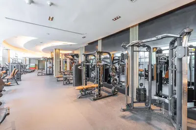 a gym with lots of treadmills and machines at StayShort - Stylish DIFC Apartment Sleeps 4 with Pool & Gym in Dubai