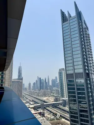 a view of a city skyline from a skyscraper at Damac Maison Mall Street,Burj Khalifa in Dubai