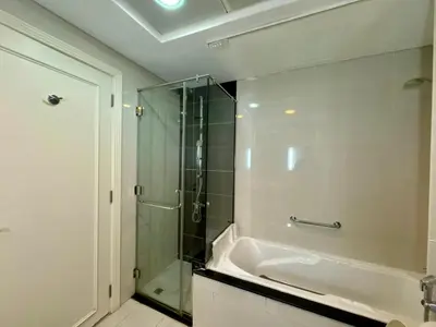 a bathroom with a shower and a bath tub at Damac Maison Mall Street,Burj Khalifa in Dubai
