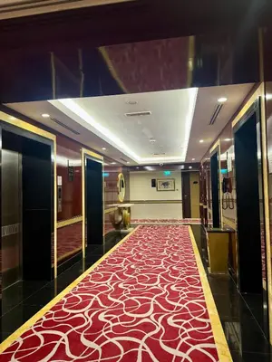 a hallway with a red carpet in a building at Damac Maison Mall Street,Burj Khalifa in Dubai