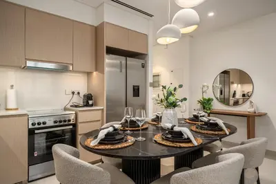 a kitchen with a dining room table and chairs at Elegant 2BR Apartment near Burj Khalifa, Downtown Dubai in Dubai