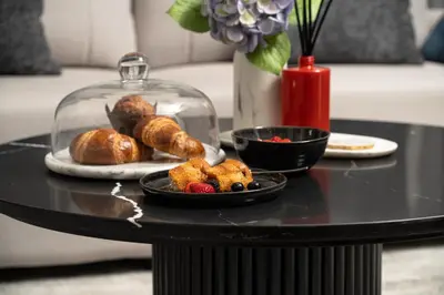 a table with a plate of pastries on a table at Elegant 2BR Apartment near Burj Khalifa, Downtown Dubai in Dubai