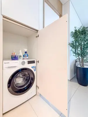 a washer and dryer in a white laundry room at Address JBR, 57th Floor Luxury Marina Beach View in Dubai