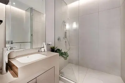 a white bathroom with a sink and a shower at Address JBR, 57th Floor Luxury Marina Beach View in Dubai