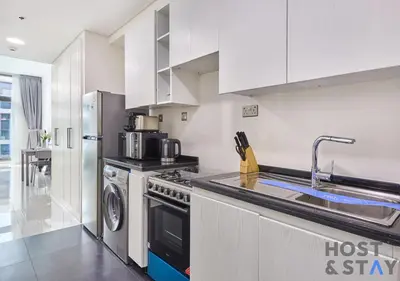 a kitchen with a sink and a stove at Bright Studio in Loreto DAMAC Hills - Pet-Friendly in Dubai