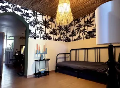 a bedroom with a bed and a wall with palm trees at Palm Oasis Guest House in Dubai