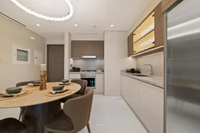 a kitchen and dining room with a table and chairs at Werova - Luxury 2-Bedroom Apartment with Sea View in Dubai