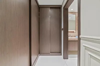 a bathroom with a walk in closet with a mirror at Werova - Luxury 2-Bedroom Apartment with Sea View in Dubai