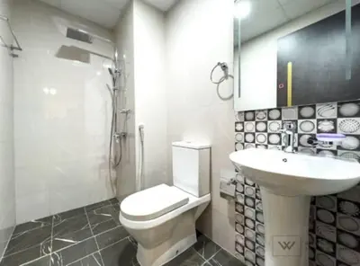 a bathroom with a toilet and a sink at Huge luxurious 1 bedroom in Dubai