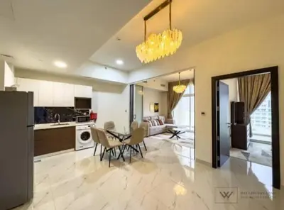 a kitchen and dining room with a table and chairs at Huge luxurious 1 bedroom in Dubai
