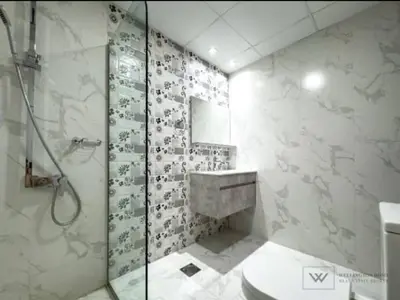 a bathroom with a shower and a sink and a toilet at Huge luxurious 1 bedroom in Dubai