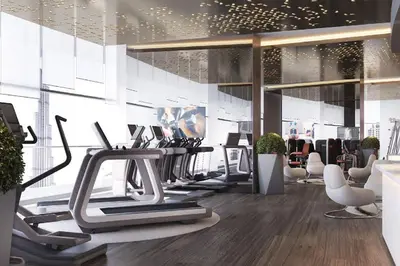 a gym with a lot of treadms and ellipticals at Stylish 2BR Paramount Apt Near Downtown in Dubai