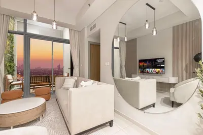 a living room with a couch and a mirror at Cozy Sunset Retreat - Burj, Palm & Sea View - 2 BR in Dubai