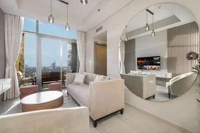 a living room with a couch and a table at Cozy Sunset Retreat - Burj, Palm & Sea View - 2 BR in Dubai