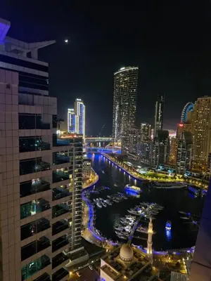 a view of a city skyline at night at Dubai marina ,1BHK ,full marina view,partial sea view ,near marina walk, marina mall and JBR in Dubai