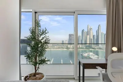 a living room with a view of a city at Elegant 2BR in Beachfront with Stunning Marina Views in Dubai
