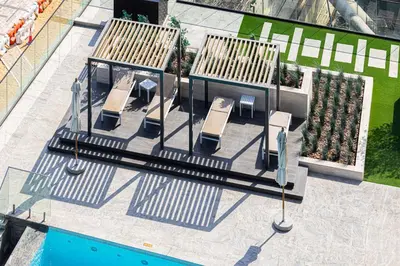 an overhead view of a playground with benches and a pool at Livin' Holidays - Studio - Canal view with jacuzzi in Dubai