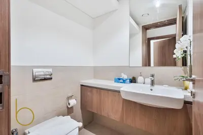 a bathroom with a sink and a toilet and a mirror at Bookable - 4 Bedroom Elan 1 Tilal Al Ghaf Villa in Dubai