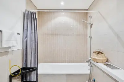 a bathroom with a tub and a shower at Bookable - 4 Bedroom Elan 1 Tilal Al Ghaf Villa in Dubai
