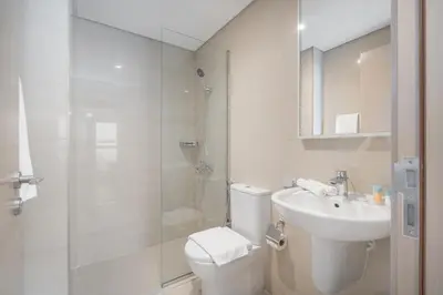 a bathroom with a toilet and a sink and a shower at Luxury 3BR, MaidRoom Full Burj & Fountain Views in Dubai