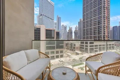 a balcony with a view of a city skyline at Lavish 1-Bedroom with Burj Khalifa view in Peninsula in Dubai