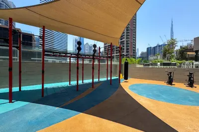 a view of a gymnasium with people on the rings in a building at Lavish 1-Bedroom with Burj Khalifa view in Peninsula in Dubai