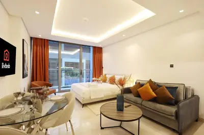 a living room with a couch and a table at Modern Studio Near Dubai Mall Walk to Dubai Canal in Dubai