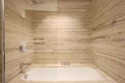 a bathroom with a bath tub in a room at Modern Studio Near Dubai Mall Walk to Dubai Canal in Dubai