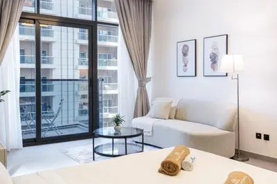 a living room with a couch and a table at Modern Home in Sports City with Rooftop Pool in Dubai