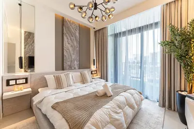 a bedroom with a large bed and a large window at HAVN - Luxurious 4 Bed Villa in Arabian Ranches 3 in Dubai