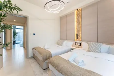 a hotel room with two beds and a couch at HAVN - Luxurious 4 Bed Villa in Arabian Ranches 3 in Dubai