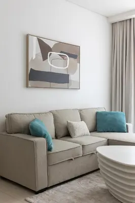 a living room with a couch and a table at Stylish One-Bedroom Oasis - Prime Palm Location in Dubai