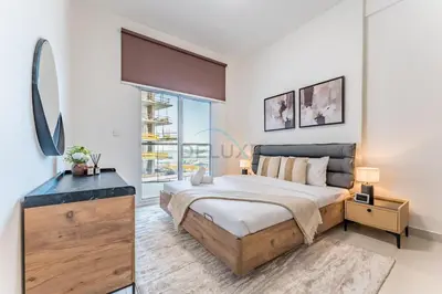 a bedroom with a large bed and a mirror at Pool View 1BR with Spacious Balcony, Short Drive to Downtown, Binghatti Gateway, Al Jaddaf by Deluxe Holiday Homes in Dubai