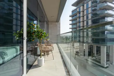 a balcony with chairs and a table on a building at Luxury 2BR and Study Water View in Al Wasl in Dubai