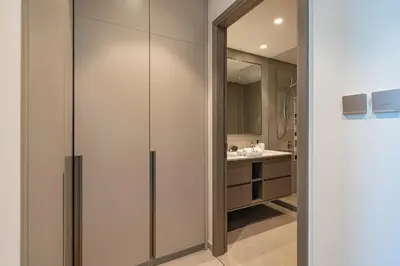 a bathroom with a walk in shower next to a sink at Stunning Burj Khalifa & Fountain Views in Dubai